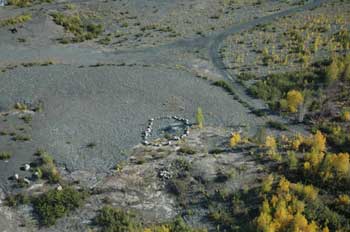 An aerial shot of boulders placed in a circle on flat ground.